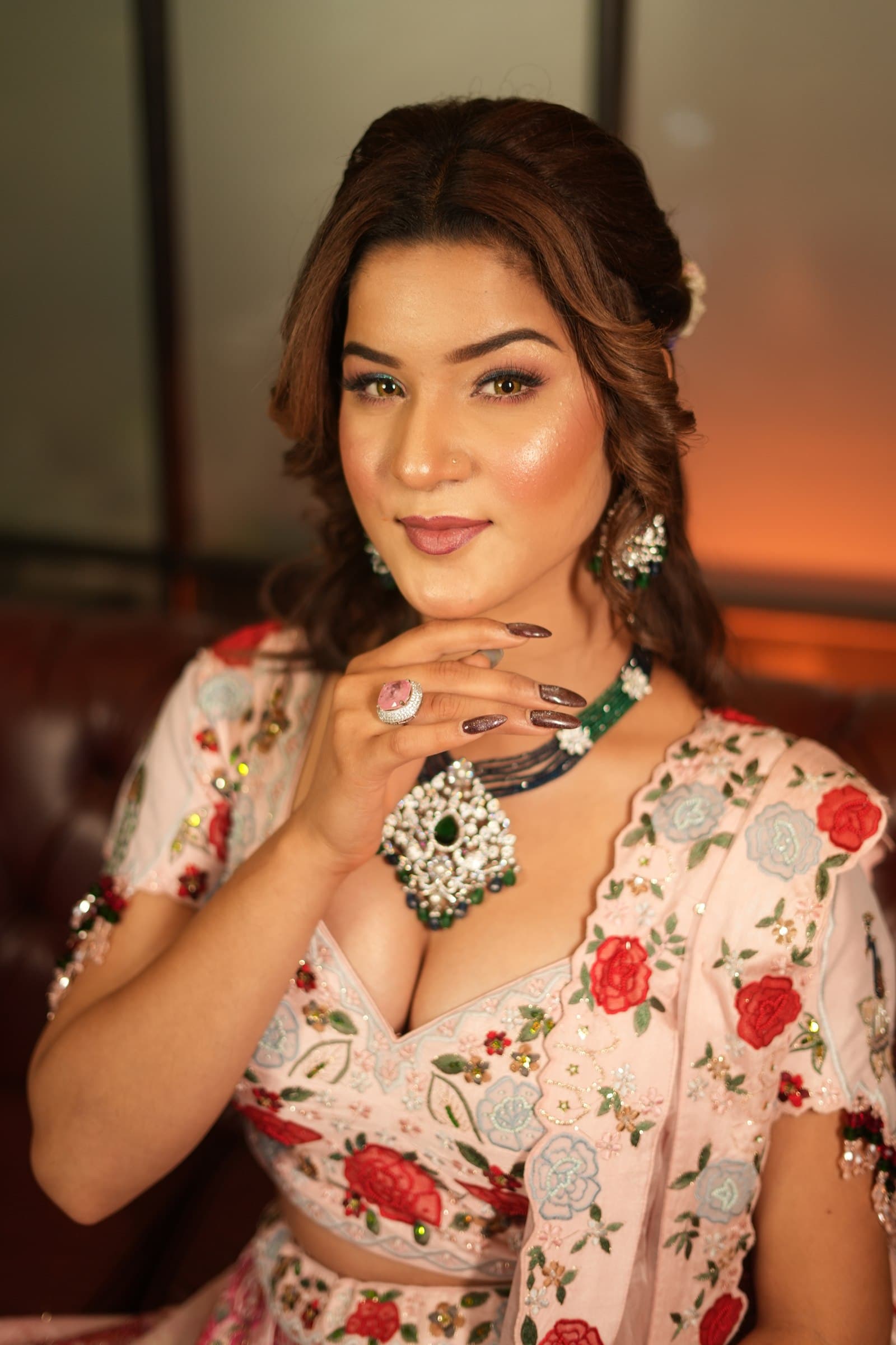 An occasion look in a rose-print outfit under warm light