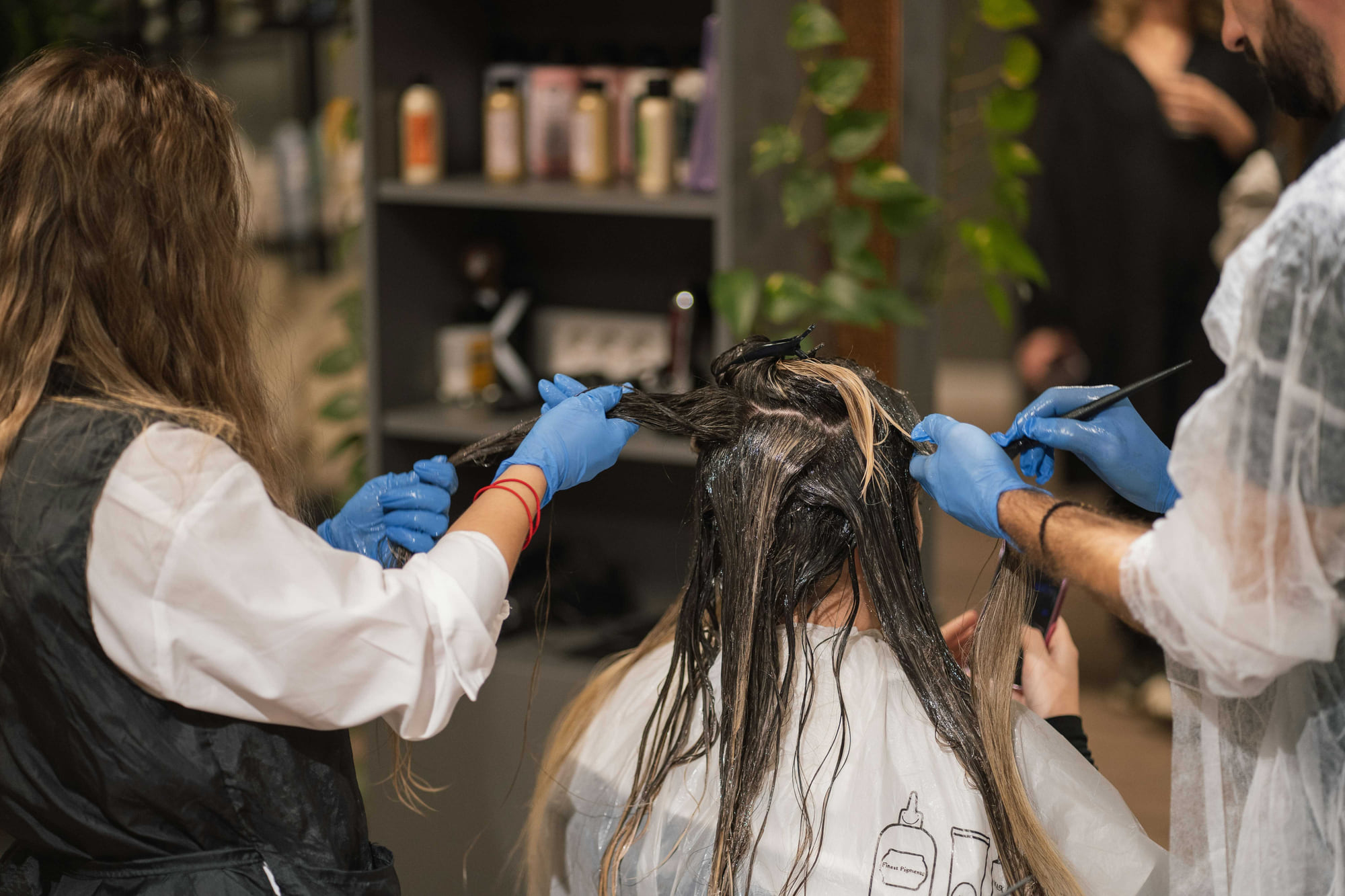 Stylists working product through long hair at Anthéa Makeover in Jalandhar