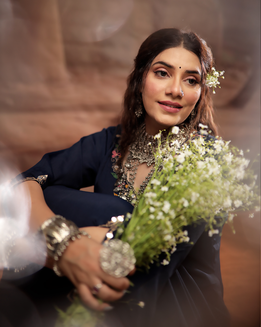 Celebrity makeup by Anthéa Makeover — luminous editorial finish with a navy outfit and baby's breath